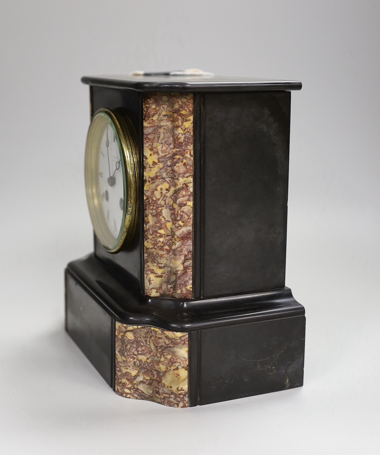 A black slate and marble mantel clock, 22cm